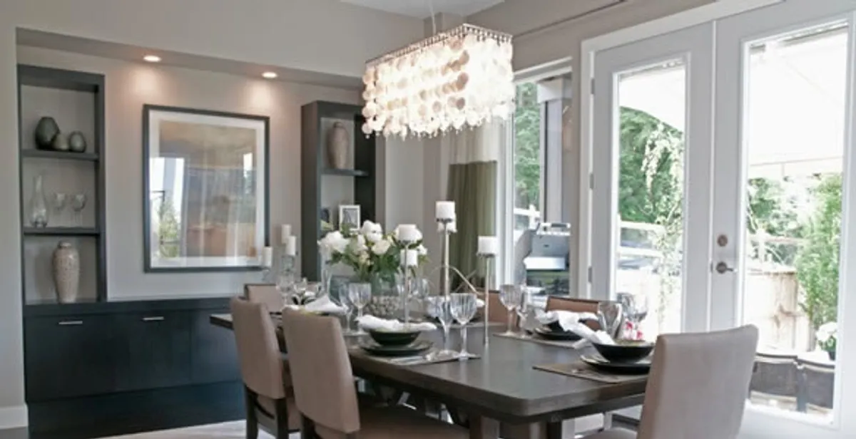 Elegant dining room chandelier installation above table in Evansville, IN