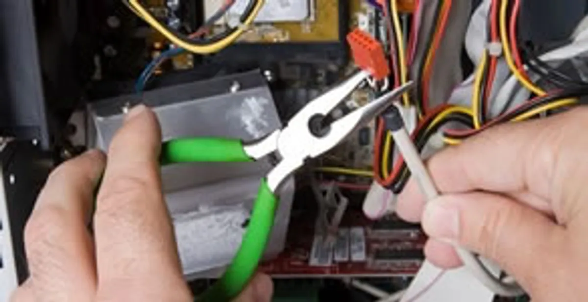 Licensed electrical contractor performing electrical repair with tools in Chandler, IN