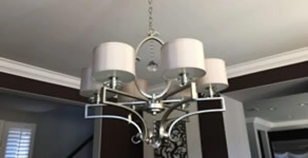 Modern chandelier installation with multiple light fixtures in Evansville, IN